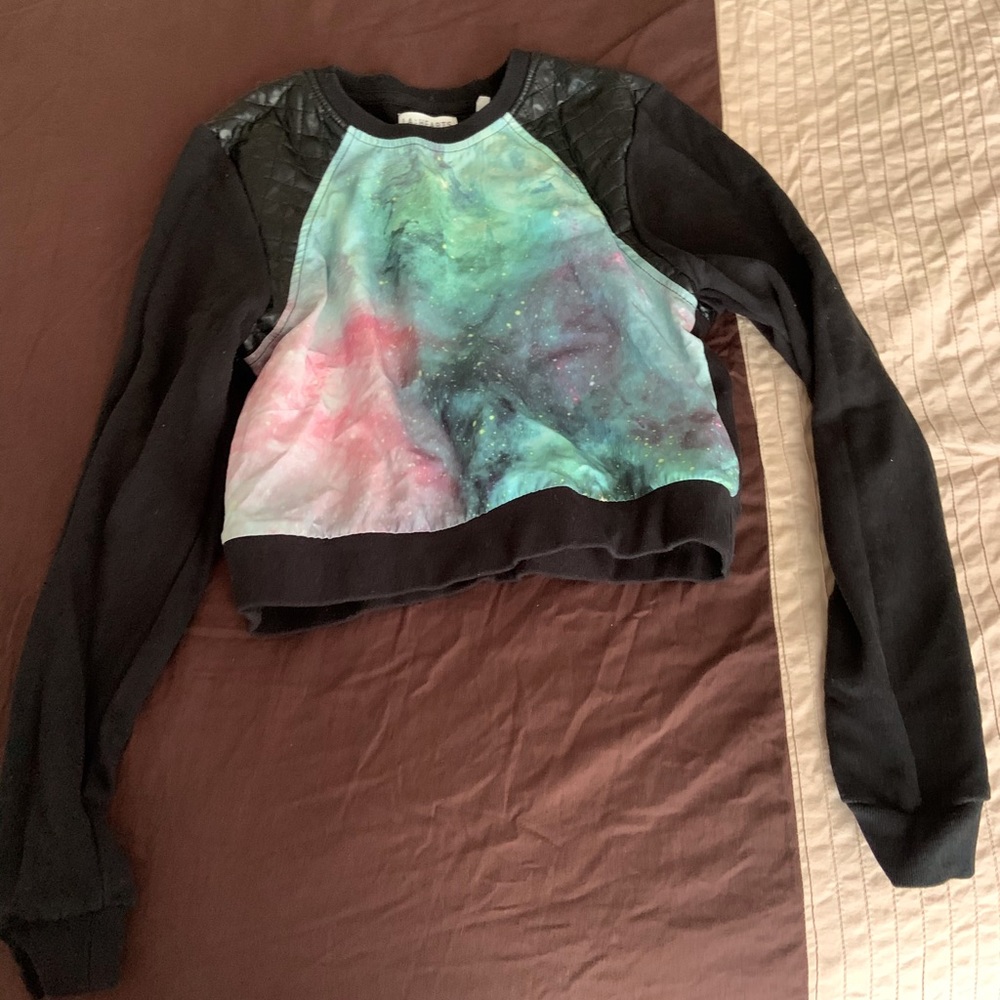 Galaxy crop sweater with leather shoulders.